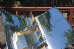 Solar reflector with steel pipe filled with water.